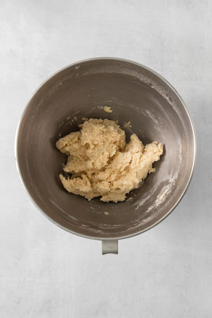 A metal mixing bowl holds the dough for cream wafer cookies.