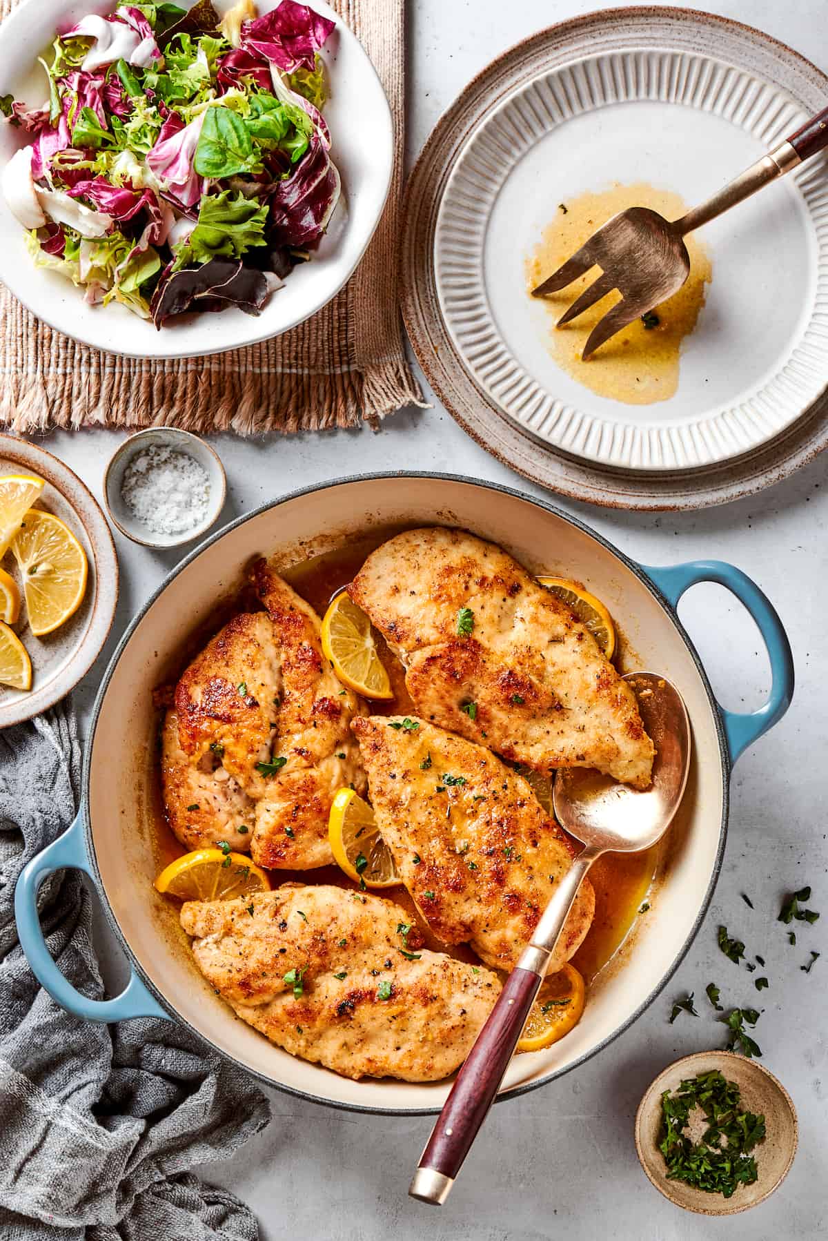 A dutch oven of lemon pepper chicken on a table.