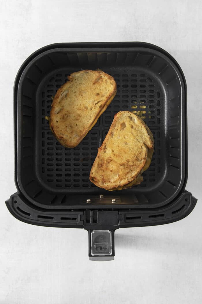 The sandwiches have been flipped over so the other side cooks in in air fryer.