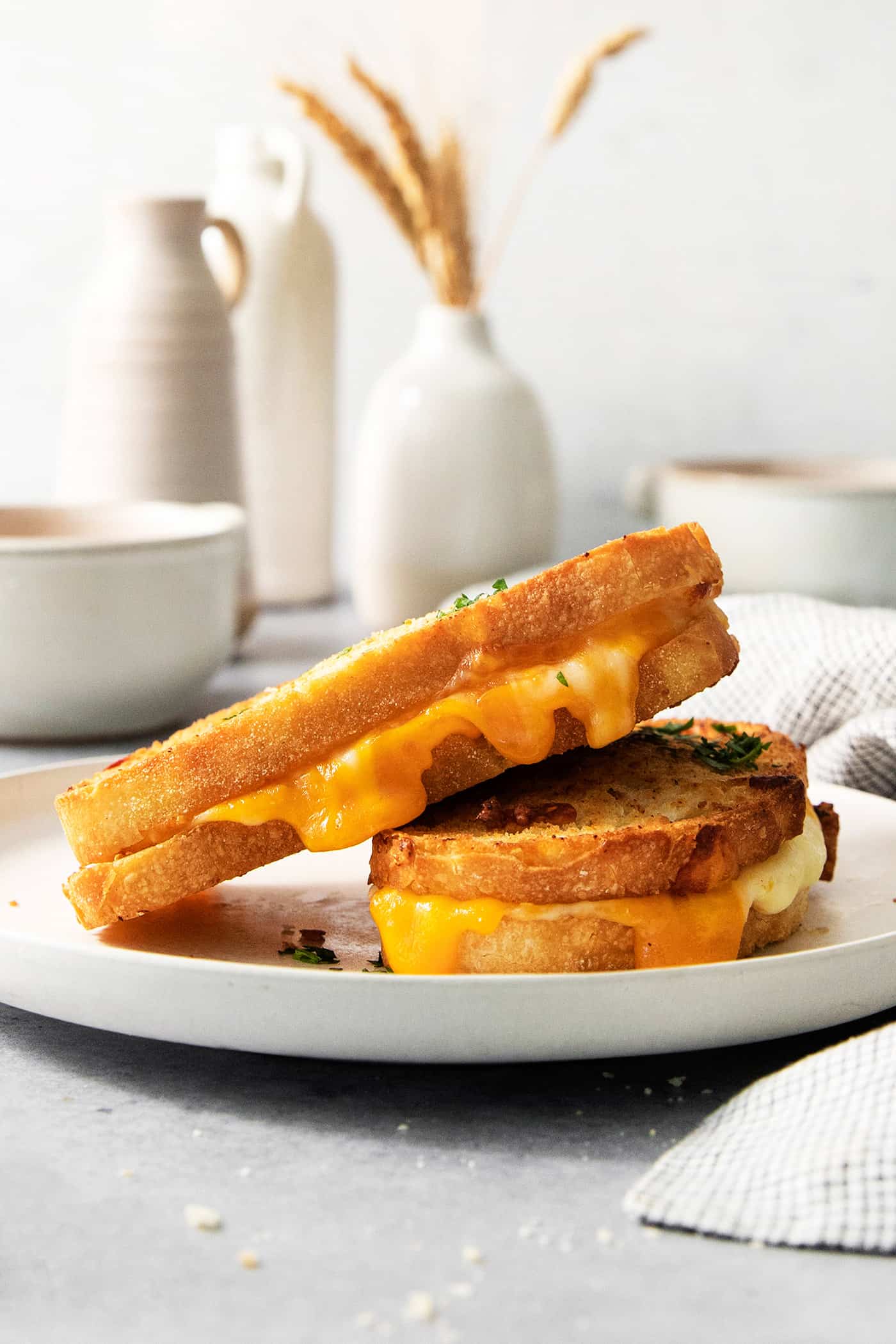 Two pieces of air fryer grilled cheese on a white plate.