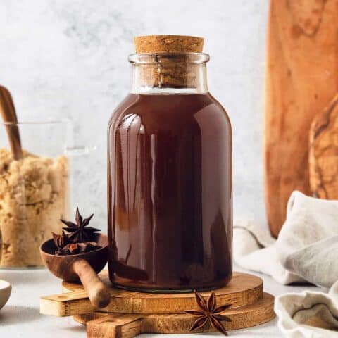 a bottle of homemade chai concentrate plus brown sugar and spices