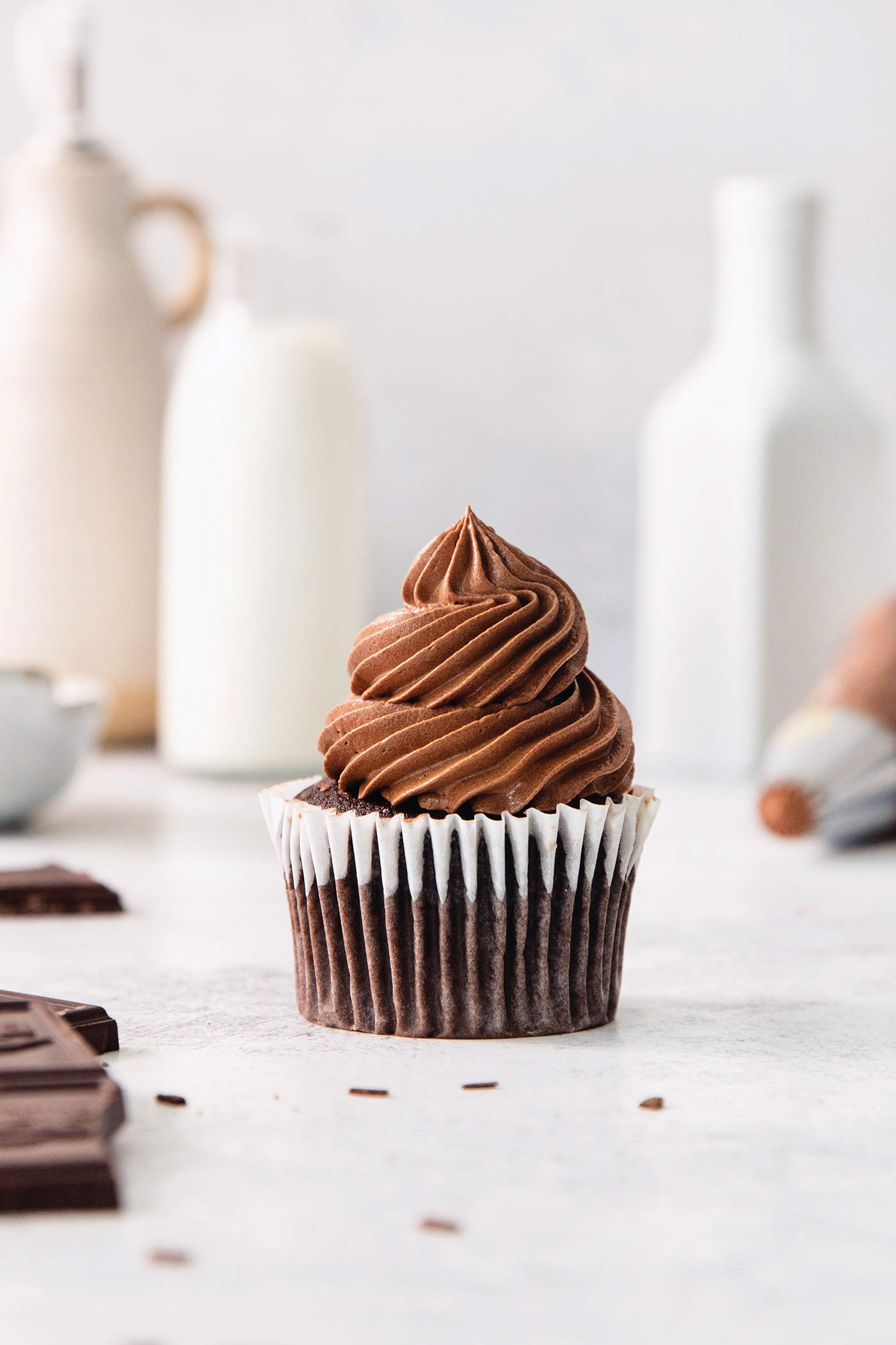A chocolate cupcakes topped with chocolate ganache frosting.