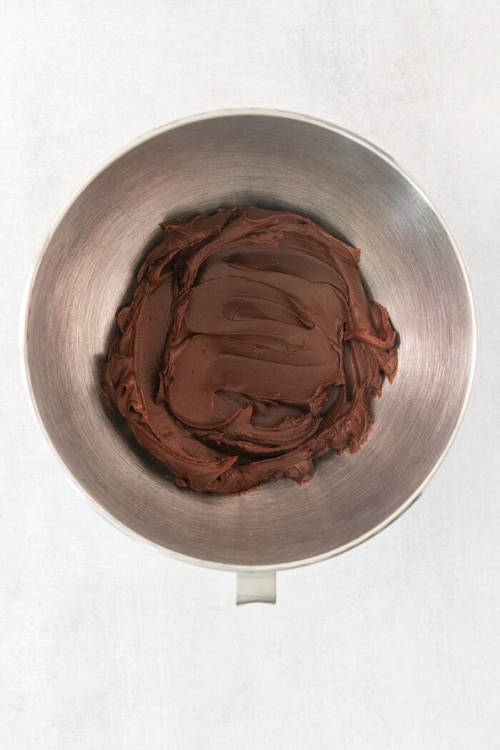 A metal bowl holds chocolate ganache.