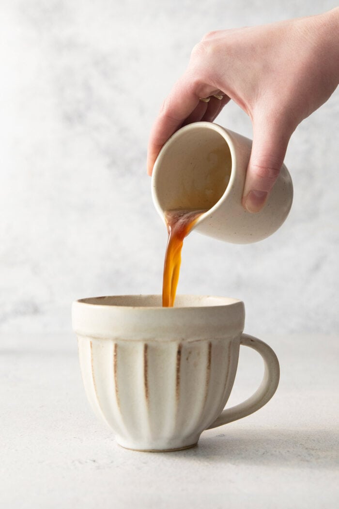 pouring espresso into a mug