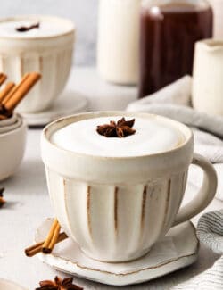 2 cream colored mugs of dirty chai latte
