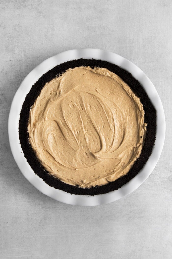 Peanut filling is added to the crust and the top is smoothed.