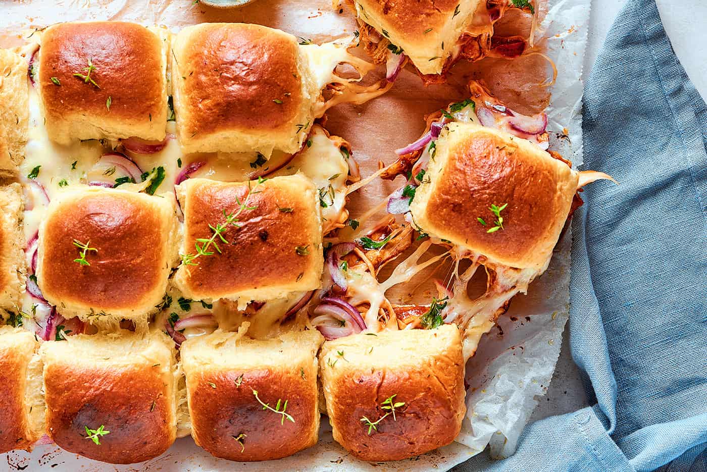 cheesy sliders on a cutting board