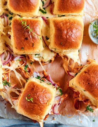 cheesy chicken slider sandwiches on a cutting board