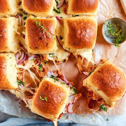 cheesy chicken slider sandwiches on a cutting board