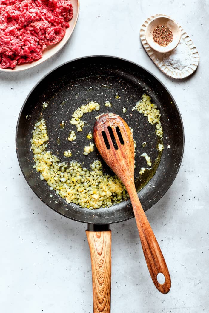 Garlic and onion cook down.