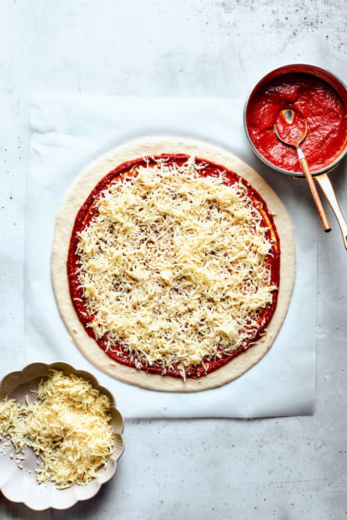 Cheese is arranged on top of the sauce.