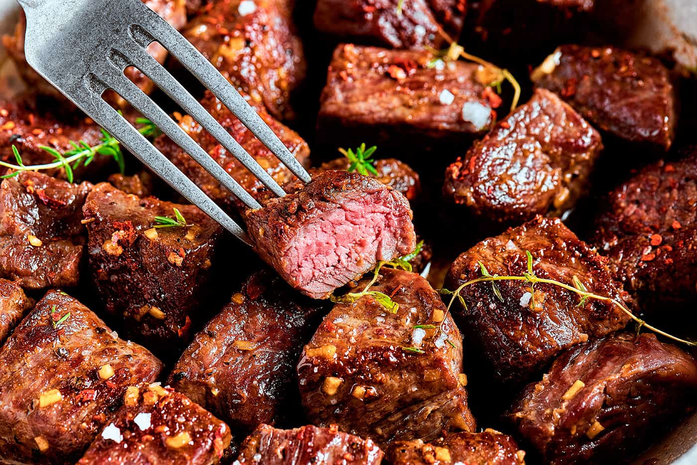 close-up photo of garlic butter steak bites, with one cut through the center