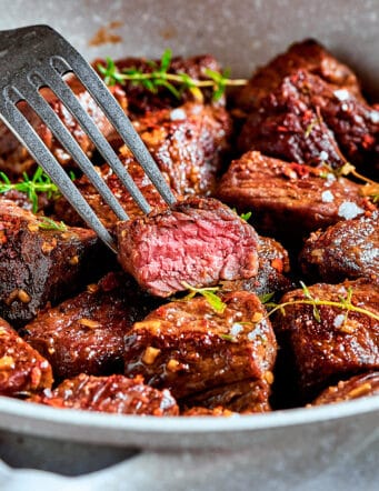 steak bites with garlic butter in a skillet