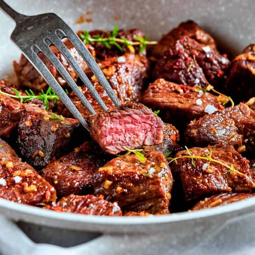 steak bites with garlic butter in a skillet