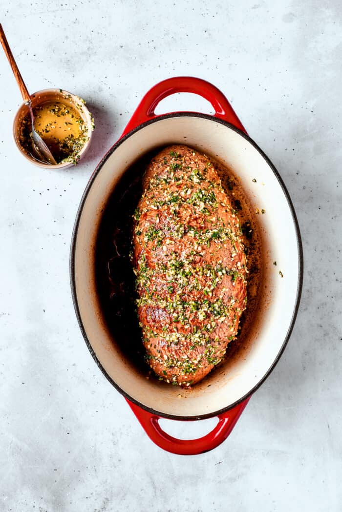 The seasoned roast is show in in the baking dish.