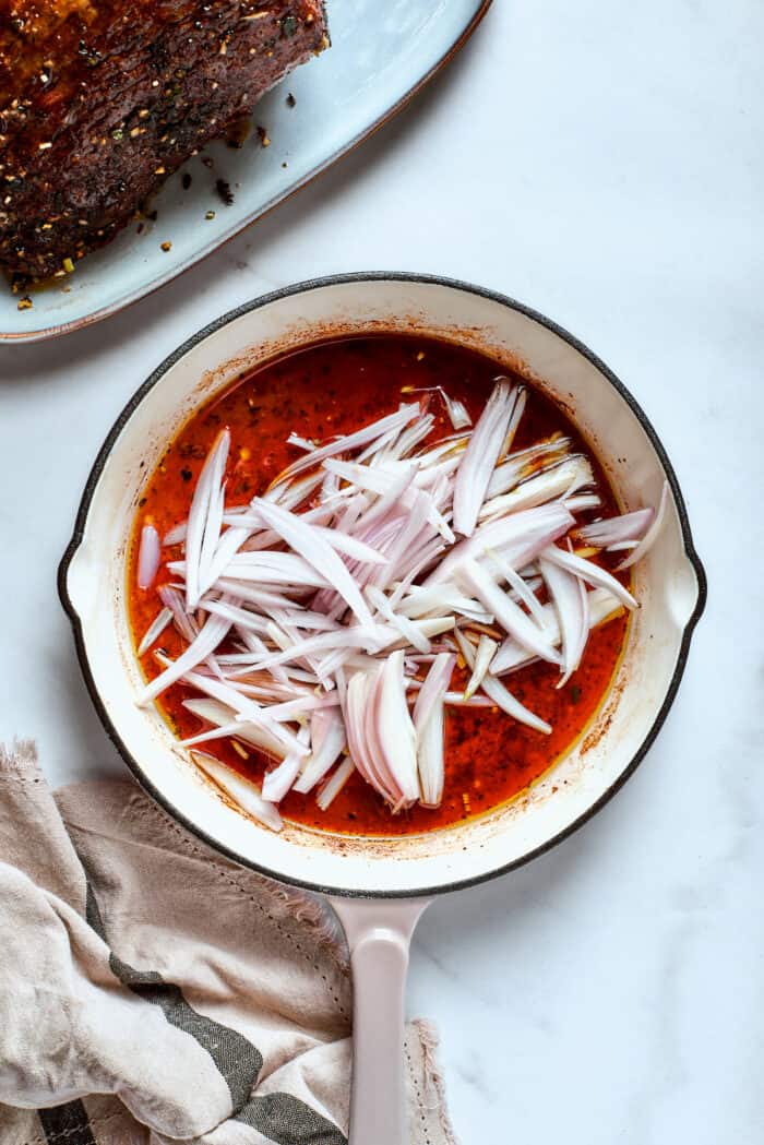 Shallots are added to the gravy base.