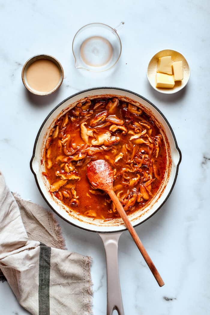 Seasonings are stirred into the gravy.