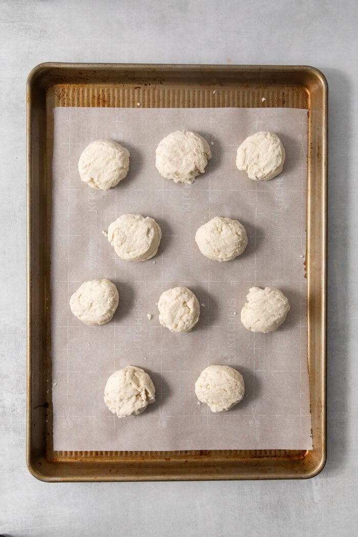 Ten biscuits on a baking sheet.
