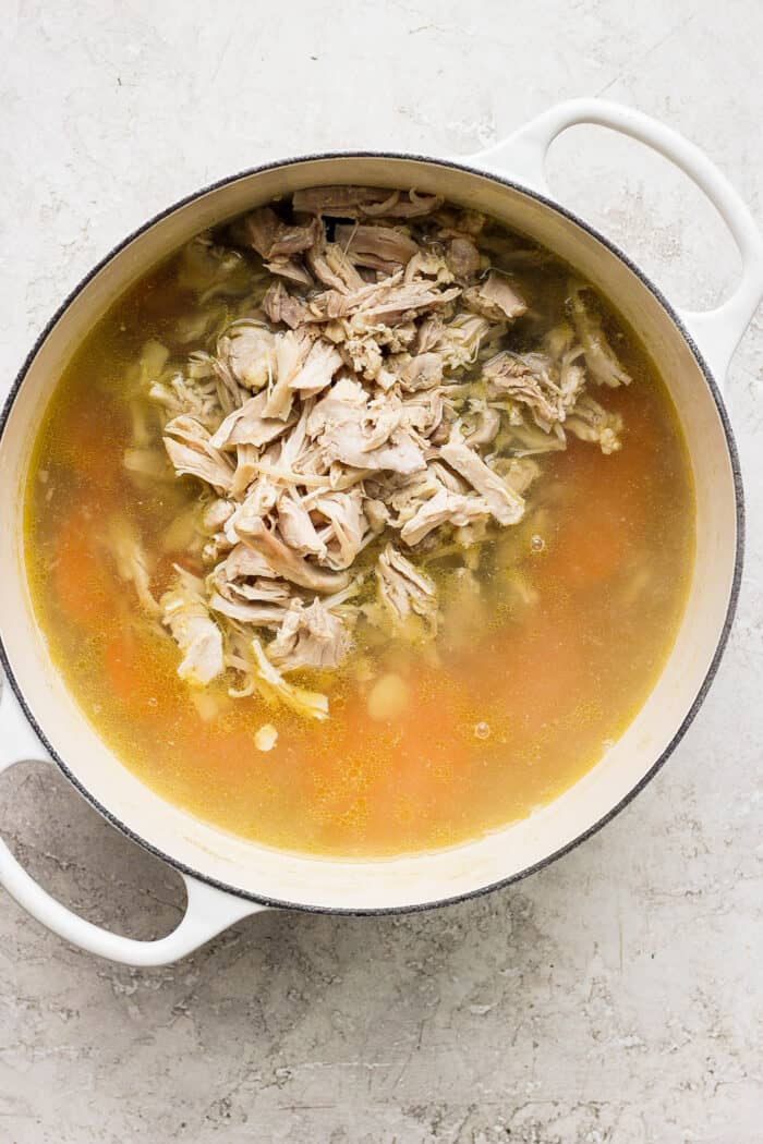 The shredded chicken is added into the soup.