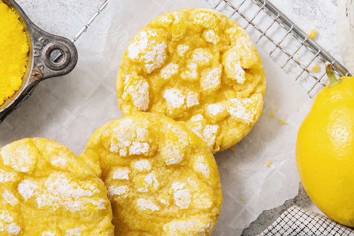Powdered sugar tops lemon crinkle cookies.