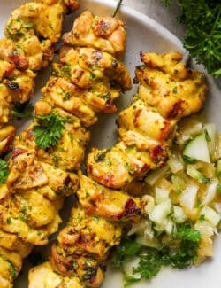 Chicken kabobs with Meyer lemon salsa are arranged on a plate