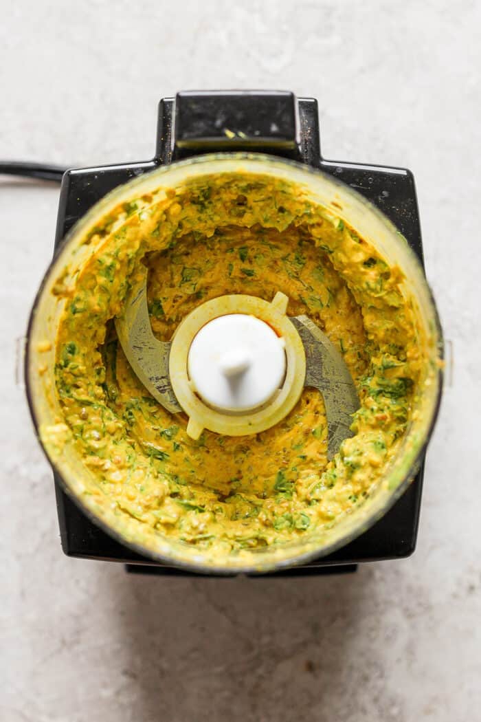 The seasoning marinade is blended in a food processor.