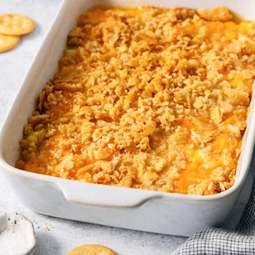 A white baking dish holds cracker-topped pineapple casserole.