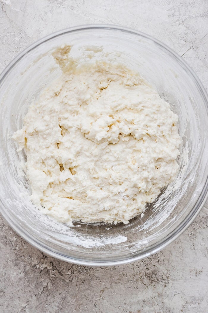 Crumbly touch of grace biscuit dough is shown in a glass bowl.