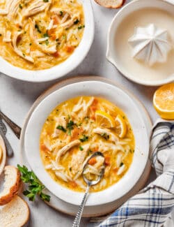 overhead photo of bowls of chicken soup with lemon and orzo