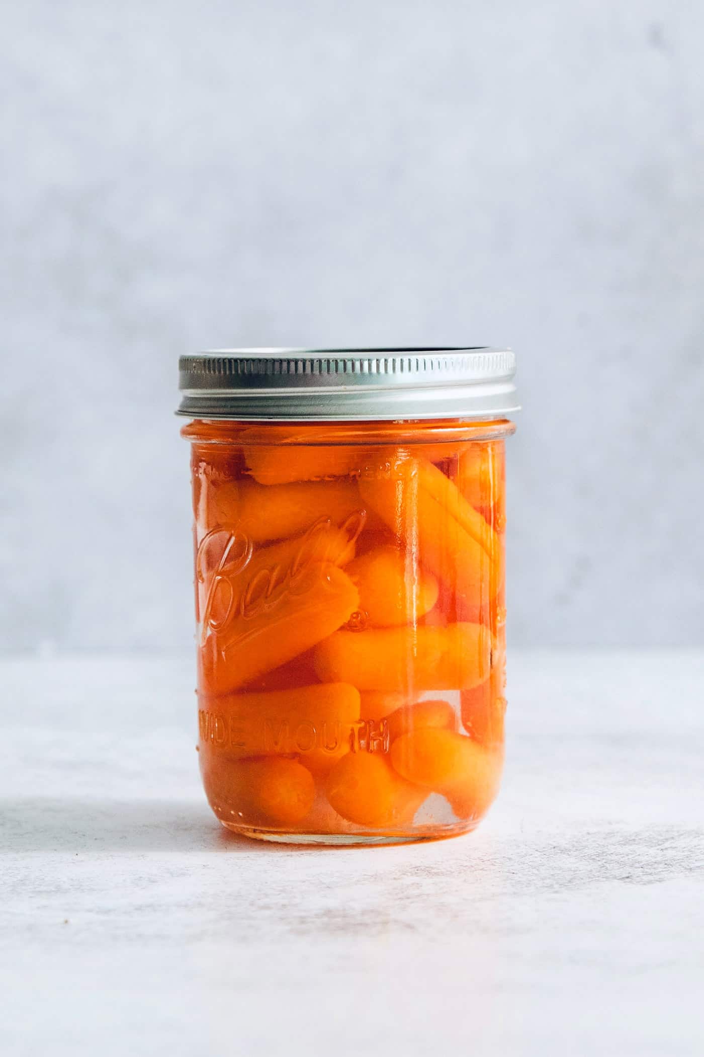 bagged baby carrots in a jar of water