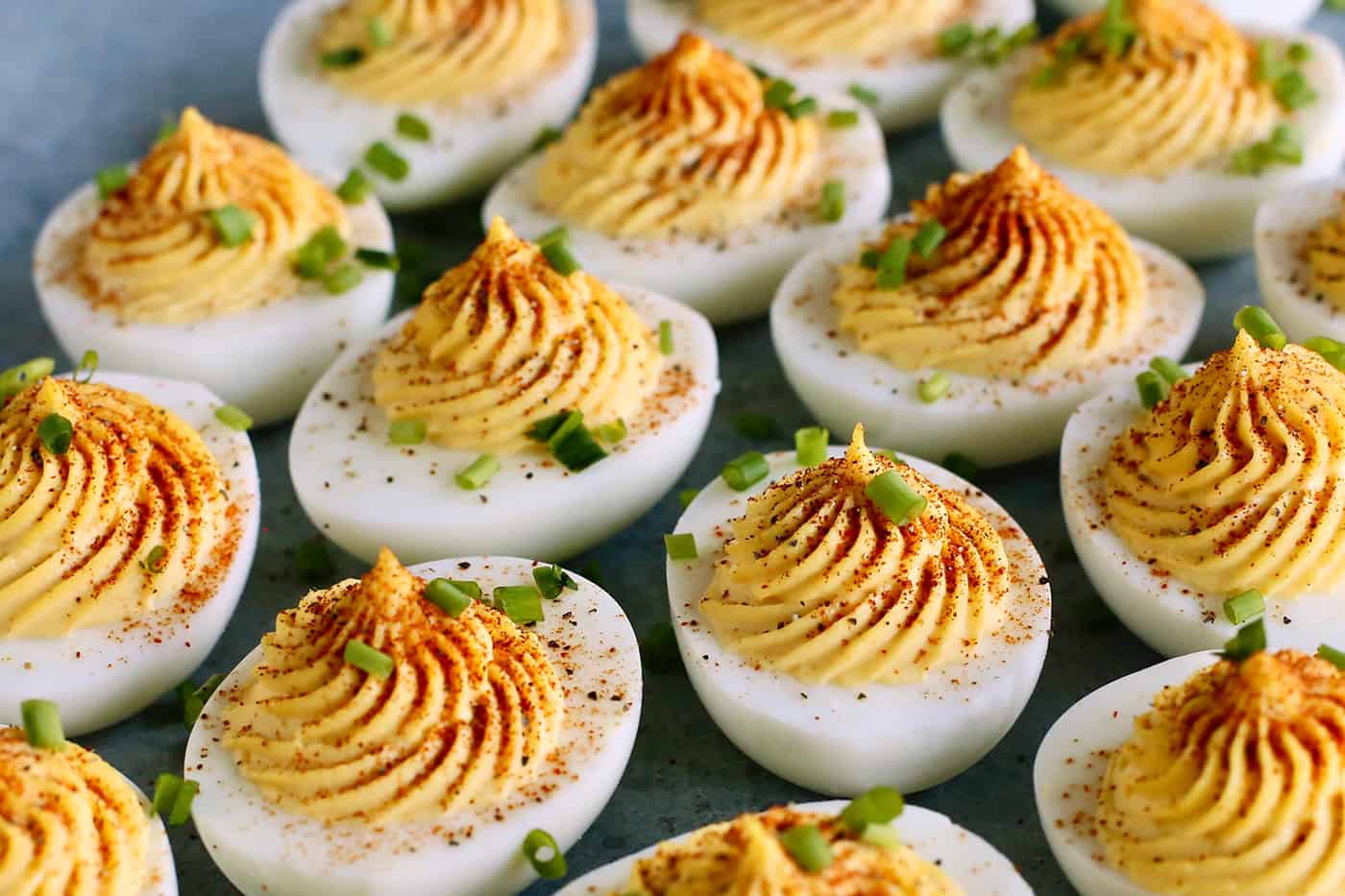 classic deviled eggs garnished with paprika and chives