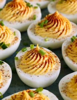 deviled eggs with paprika and chives garnish