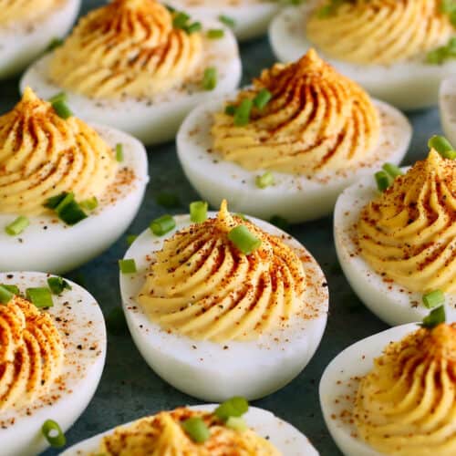 deviled eggs with paprika and chives garnish