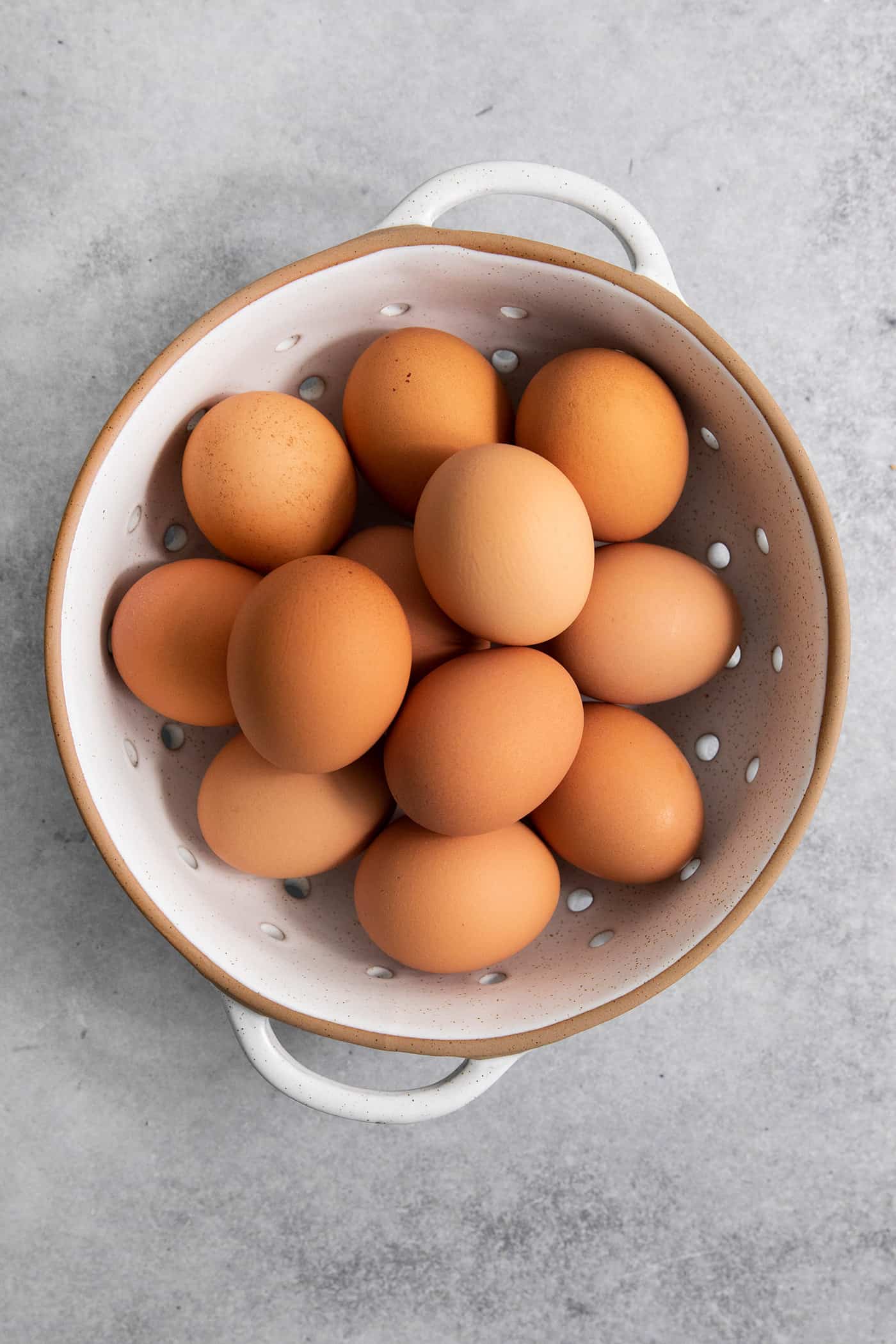 brown eggs in a white colander