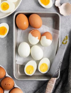 overhead photo of hard boiled eggs that show the shell coming off perfectly