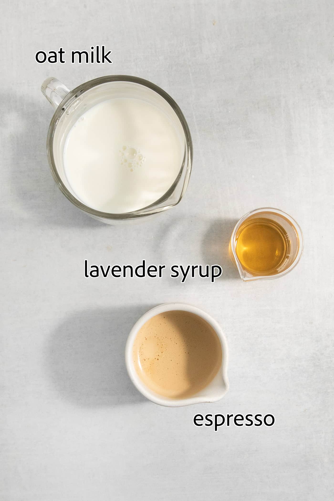ingredients to make a lavender latte: oat milk, lavender syrup, and espresso