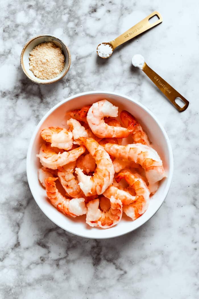 Pieces of shrimp for shrimp for shrimp shumai in a bowl.