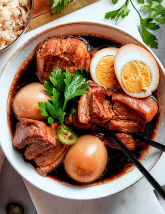 overhead photo of thit kho in a bowl, with a hardboiled egg cut in half