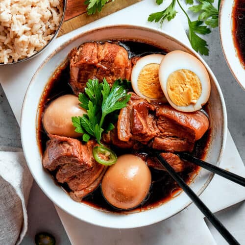 overhead photo of thit kho in a bowl, with a hardboiled egg cut in half