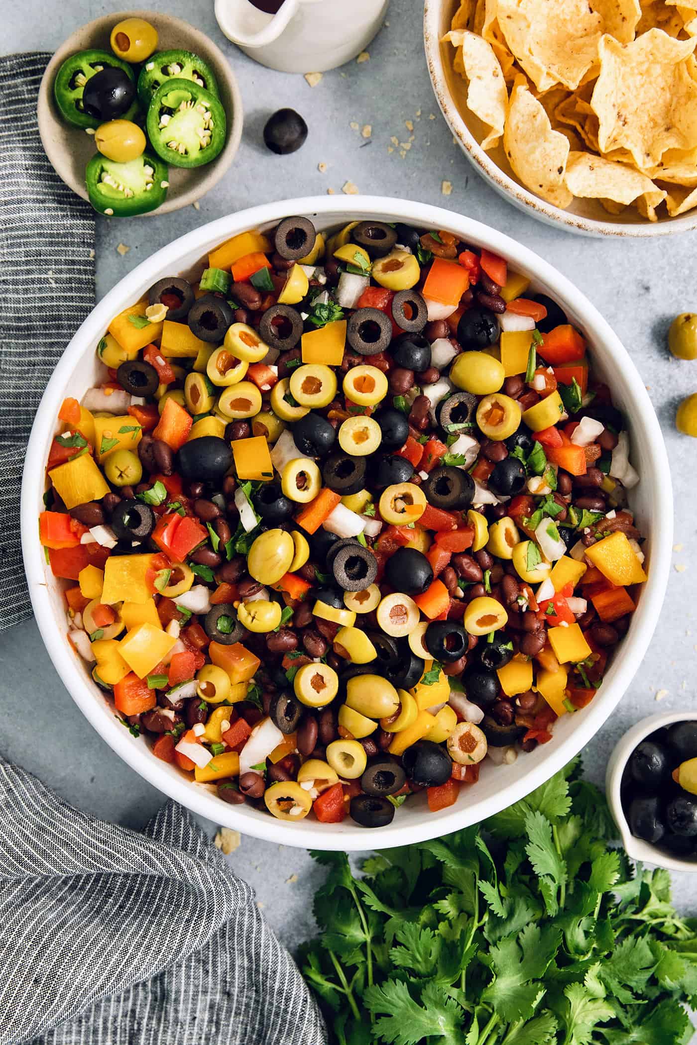 Olives top a big bowl of black bean salsa.