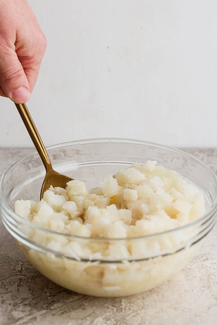 A spoon stirs a bowl of classic ceviche.