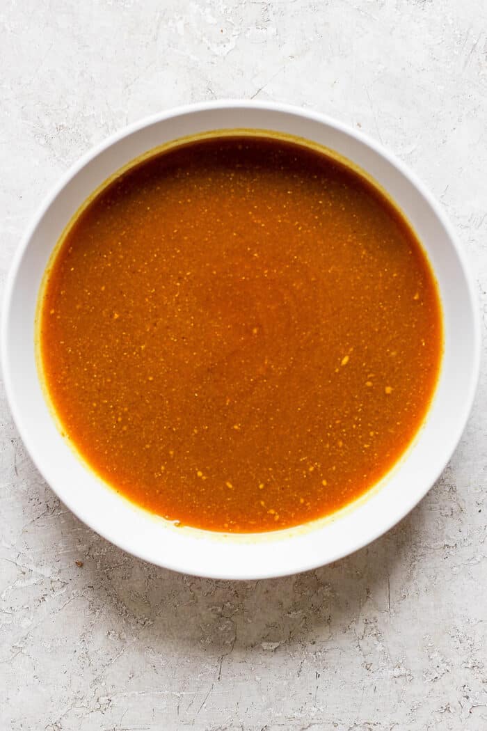 A bowl of honey mustard sauce to make honey mustard chicken kabobs.