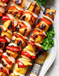 Grilled honey mustard chicken kabobs on a plate.