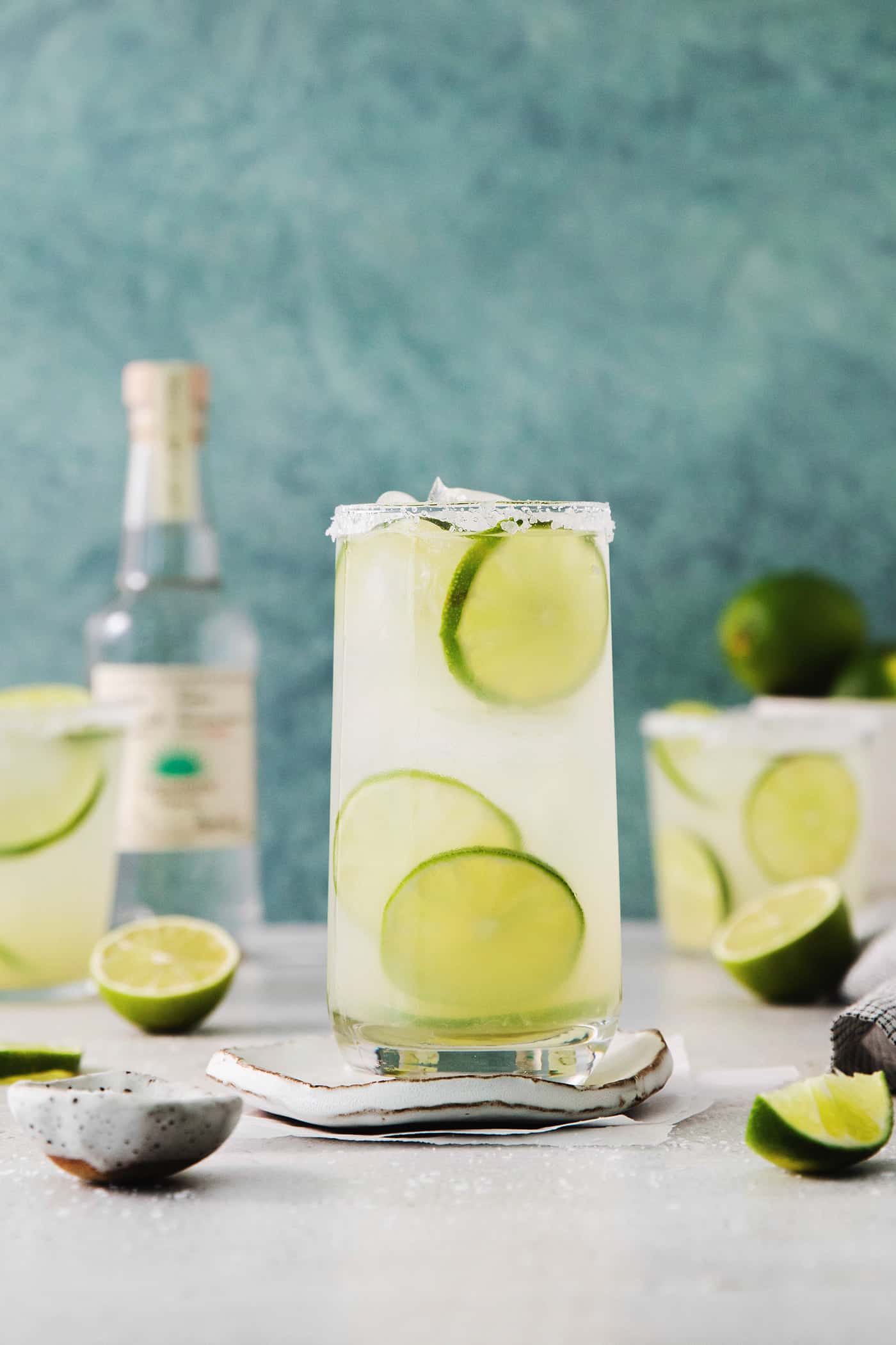 Glasses of classic margarita with lime slices floating in them.