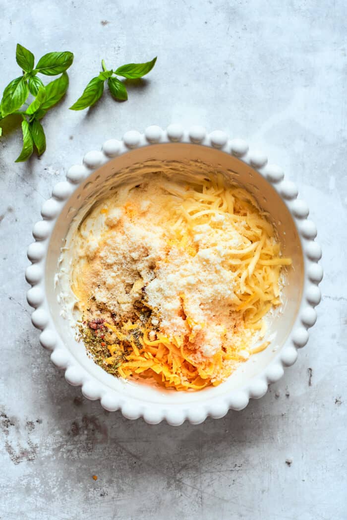 Cheese and spices are added to the dish.