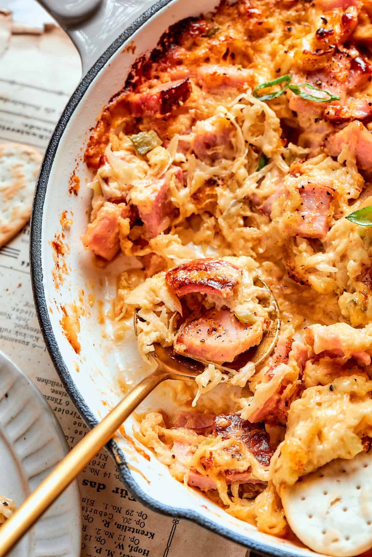 A spoonful of Reuben dip in a pan