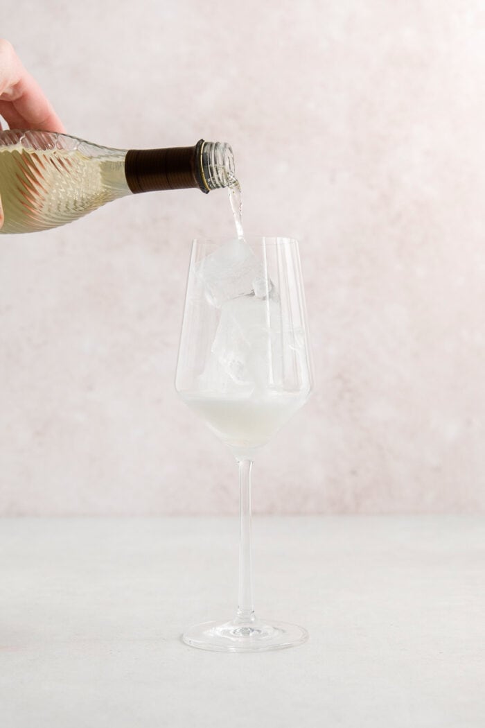 Procecco is poured into a wine glass.