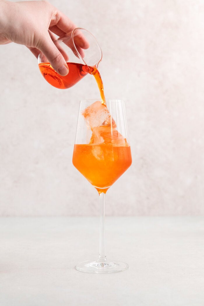Aperol is poured into the glass.