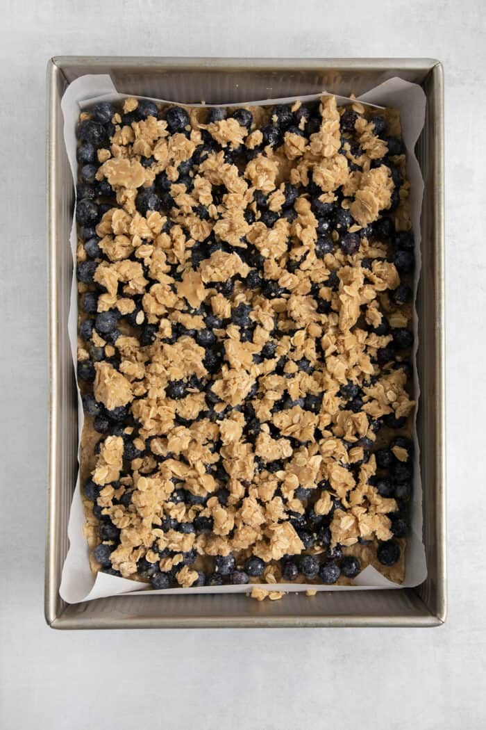 The remaining crumble is placed on top of the blueberries.