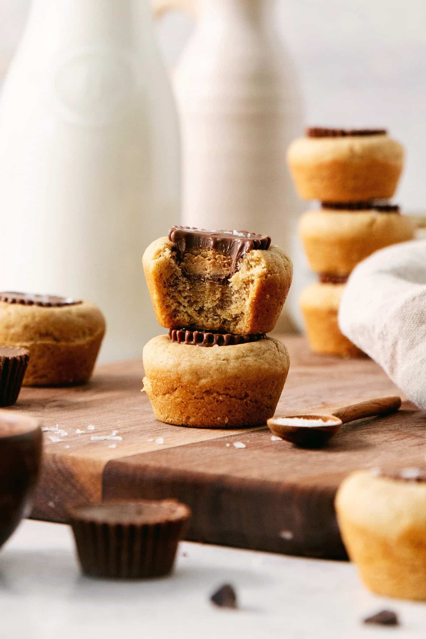 Peanut butter cup cookies are shown with a cookie with a bite taken out.
